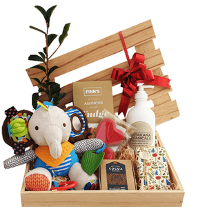 Newborn baby gift hamper with toys, chocolates and body care in wooden gift box