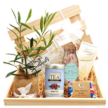 Wooden gift hamper with a living olive tree , body care, tea, biscuits, chocolate and manuka soap