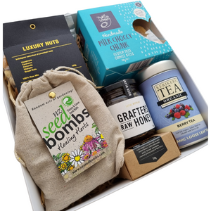 Gluten free gift box includes tea, honey, biscuits, nuts, cocoa and wildflower seed bombs to grow