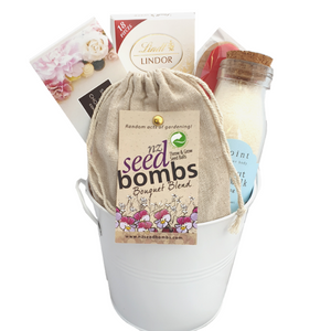 Gift tin with a bag of wildflower seed bombs, chocolates and body care 